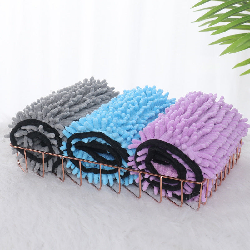 Three microfiber pet towels in blue, gray, and purple, with hand pockets, arranged on a wire rack.