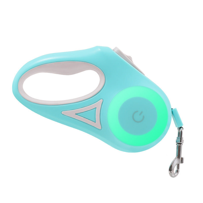A retractable dog leash with a collar and LED light, held by a person sitting on a chair, attached to a corgi dog.