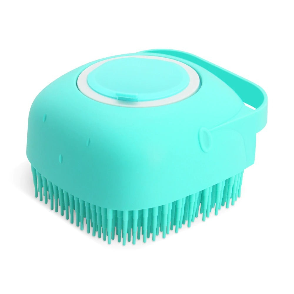 Three kittens sitting in a metal bucket with a blue silicone pet bath and massage brush in front.