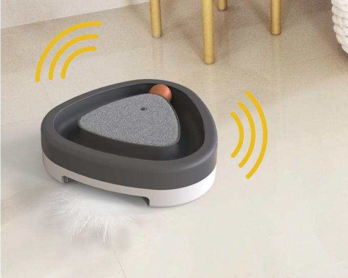 Pet toy with gray surface and brown ball on a light floor.