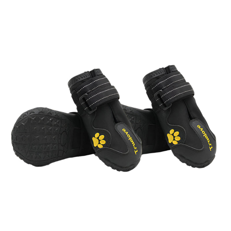 Black dog boots with yellow paw prints on a white background