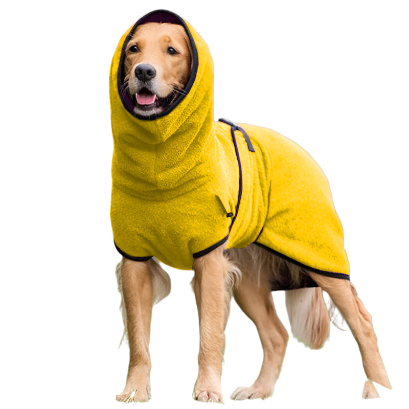 Dog wearing a yellow hooded towel outdoors