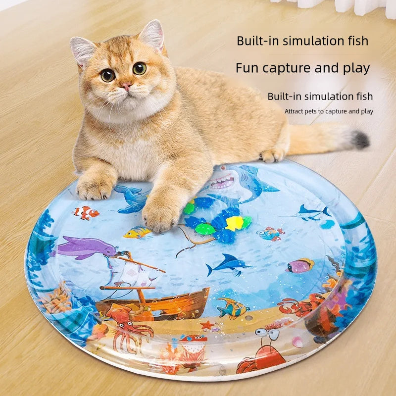 Cat playing with a round mat featuring underwater scene and simulation fish.