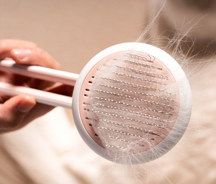 Pet hair removal brush with collected pet hair on a neutral background